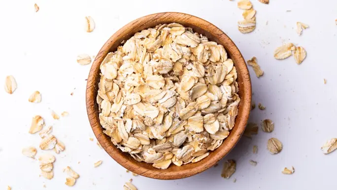 Rolled oats in a wooden bowl
