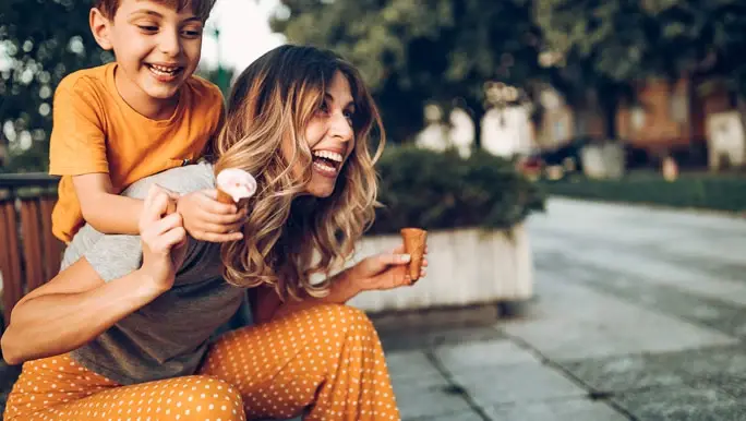 Happy mum and her son out eating ice cream for a treat