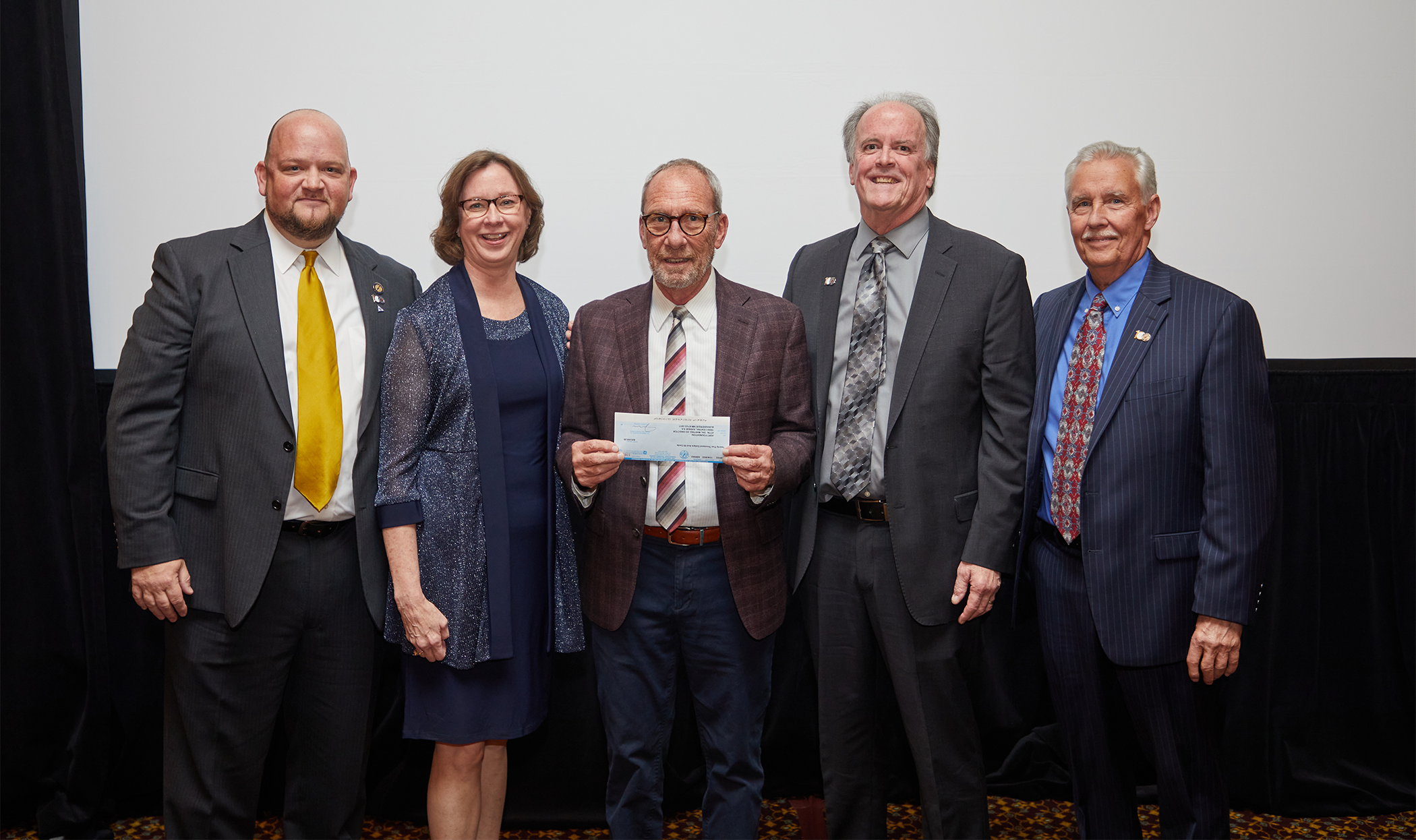 Four of ARRT’s Board of Trustees plus Jerry B. Reid, holding a check for $25,000 - a donation to the American Society of Radiologic Technologists (ASRT) Foundation’s Sal Martino Leadership Scholarship