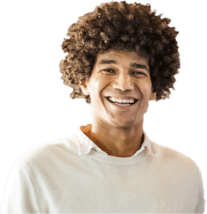 A man with a cool afro hairstyle & white sweater, flashing a bright smile.