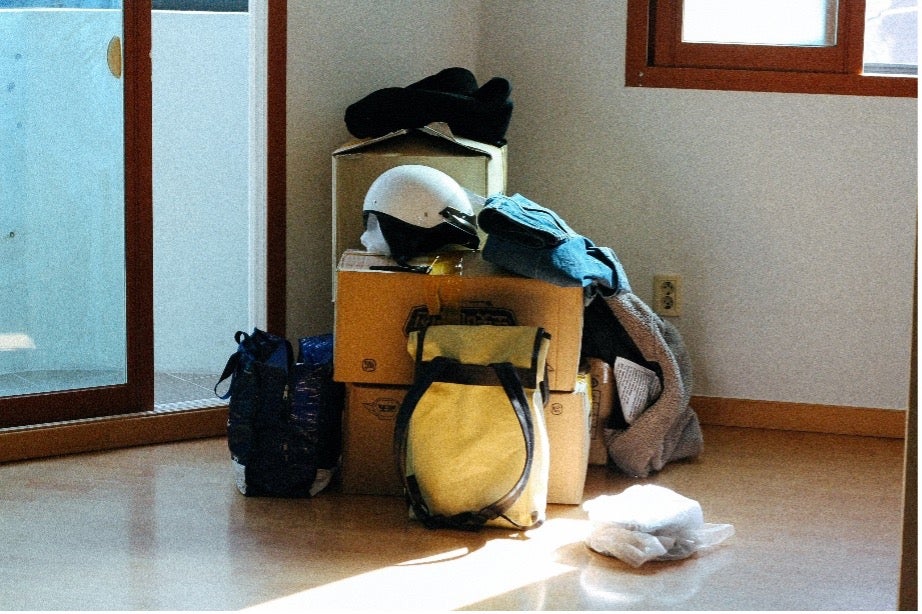 Suitcases and personal items wait by the door for a move to Finland with Atlas® International.