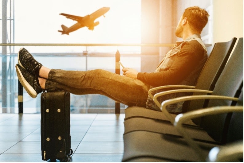 A man waits for his flight in preparation for his individual move to Singapore with Atlas® International.