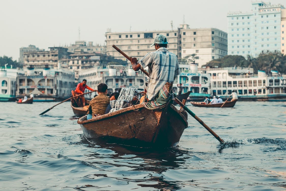 People rowing a boat in Dhaka, Bangladesh.