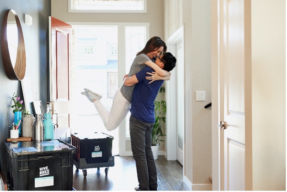 A young couple celebrates in their home after their individual move to Denmark with Atlas International.