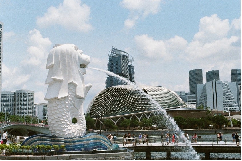 A fountain sprays water against the cityscape in Singapore.