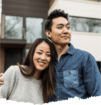 A woman and man in front of their house. A woman and man in front of their house.