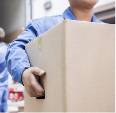 A man carrying a box. A man carrying a box.