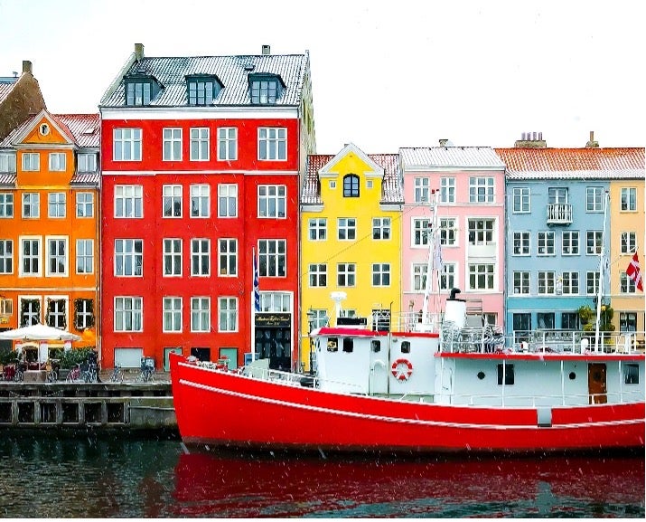 Colorful buildings sit alongside the marina in Copenhagen, Denmark.