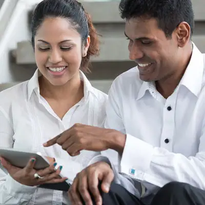 female and male colleagues having a discussion?fm=webp&q=65