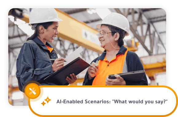 Two manufacturing workers wearing white hard hats review notes on a clipboard and tablet while talking on a factory floor. Overlay text reads “AI-Enabled Scenarios: ‘What would you say?’”
