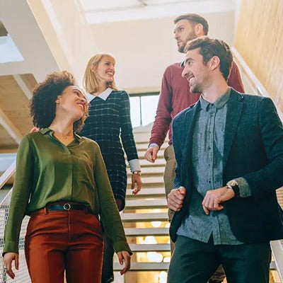 professional people walking together, perhaps having a walking meeting