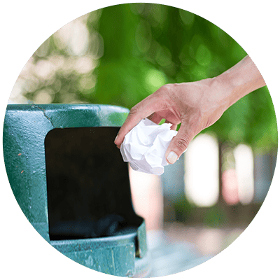 a person throwing a balled up piece of paper in the garbage can to show that a common reason why leadership development fails is when companies invest in a "one-and-done" program