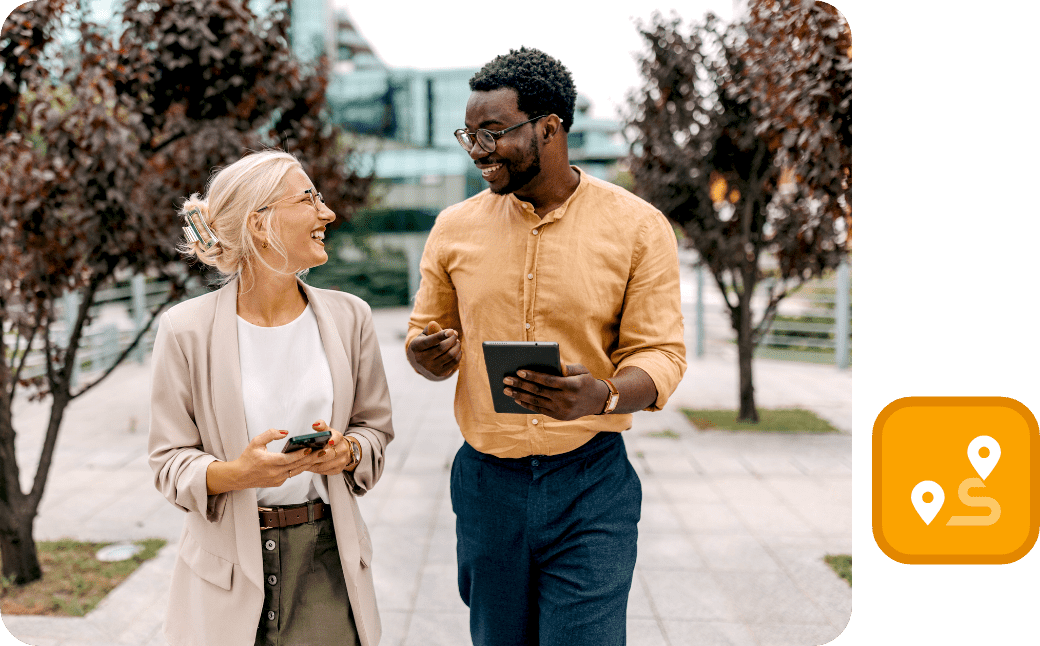 Leadership development professionals collaborating and sharing insights during a business walk.