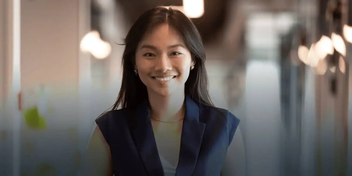 une jeune femme leader souriante et confiante pour montrer que les parcours d’apprentissage de DDI sont très efficaces pour préparer les gens à diriger à travers le changement