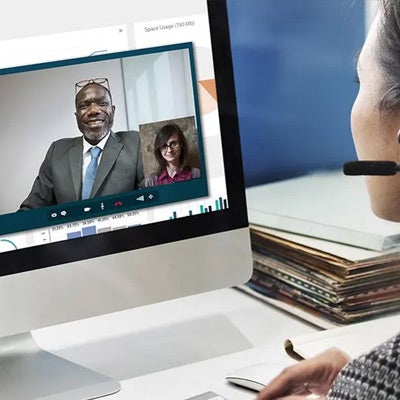 a professional woman having a video conference call on her computer