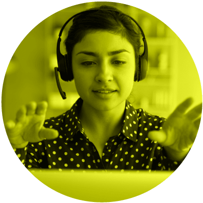 Une femme professionnelle avec un casque d’écoute qui parle à son ordinateur pour montrer que le télétravail est le numéro 10 sur la liste des sujets de leadership les plus brûlants pour 2021