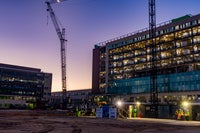 Sunset view of the building with lights on