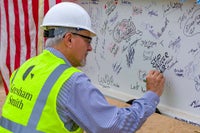 Man signing the beam