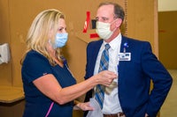 Mark Faulkner CEO of Baptist Health Care listening to Baptist team member.