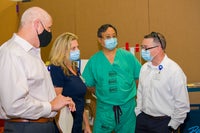 Baptist Health Care team members with masks discussing mock up day.