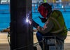 Person welding metal.