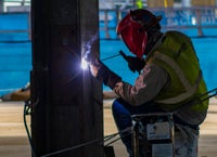 Person welding metal.