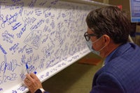 A man reading signatures on the beam