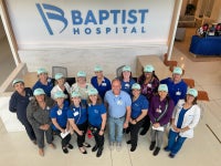 Visitor liaisons with CEO Mark Faulkner