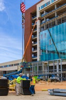 Contstruction workings with lift lifting metal parts.