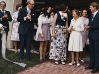 Mrs Earl Gaston cuts ribbon opening for enlarged hospital