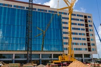 View of front of new Baptist Hospital with crane in front. 