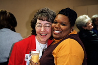 Working at a great place and creating lasting friendships two women smiling at camera