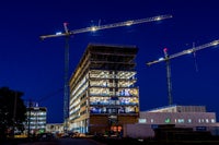 Image of the building at night with lights on