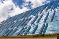 New campus exterior of glass panes on building.
