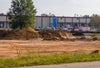 View of leveled ground with building beyond area.