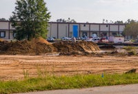View of leveled ground with building beyond area.