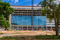 Front of new Baptist Hospital with partially windows installed.