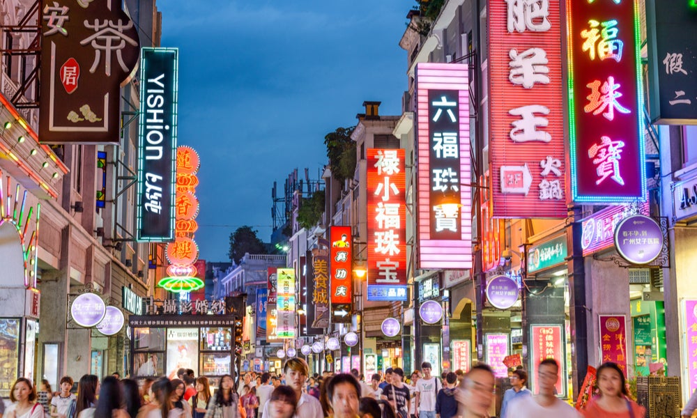 Pedestrians pass through Shangxiajiu pedestrian street in Guangzhou, City in China-min.jpg