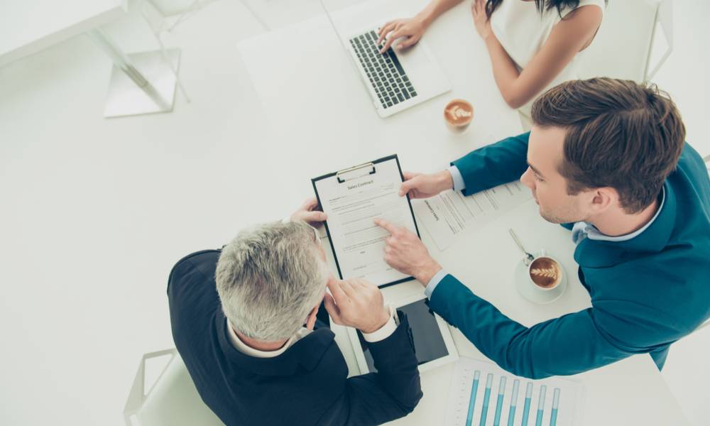 Top view of businessman pointing on one of the conditions of contract (1).jpg