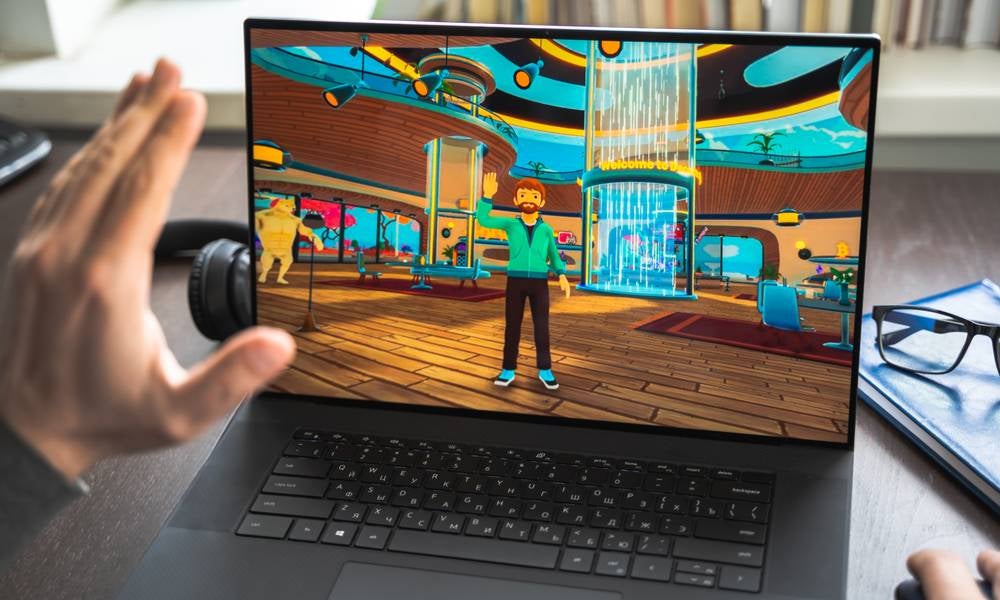 Gamer waves to his own avatar while gaming next trend in blockchain to follow Bitcoin snd NFTs.jpeg