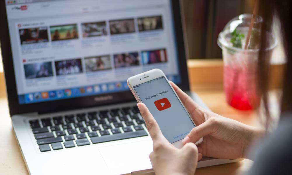 Woman accessing YouTube on her phone and computer (1).jpg