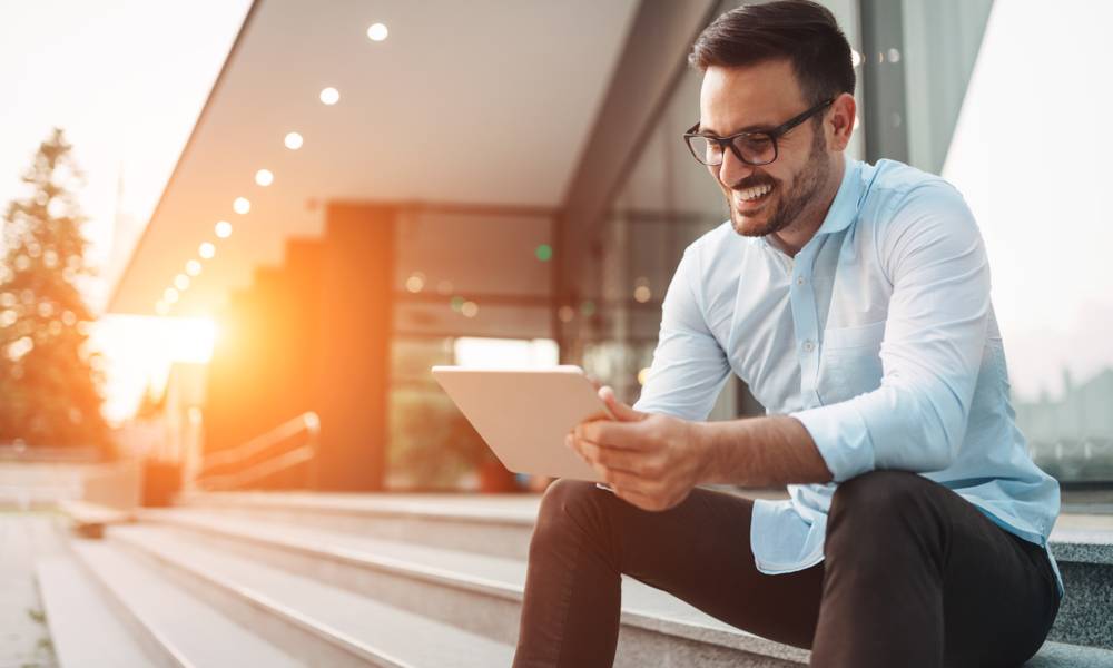 Portrait of businessman in glasses holding tablet (1).jpg