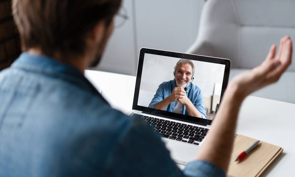 Leader talks to employee virtually communicating to gain trust during uncertainty.jpeg