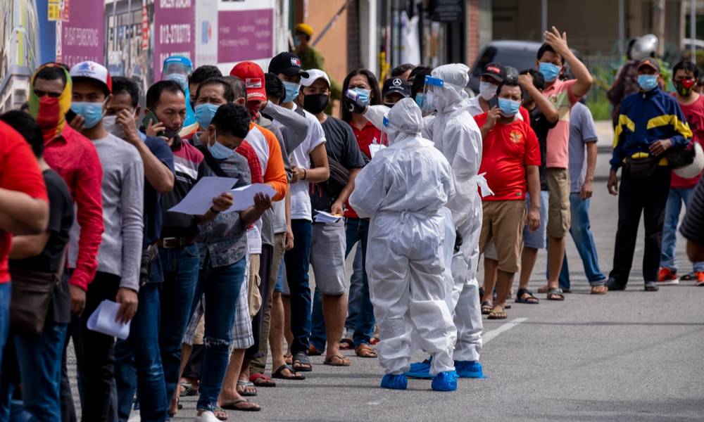 Workers line up for COVID-19 screening test.jpg