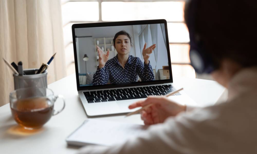 Laptop screen shows colleagues talking virtually (1).jpg
