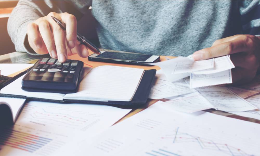 Man using calculator and calculate bills in home office.jpg