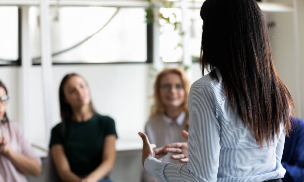 Female leader shares information with employees building trust in a time of uncertainty.jpeg