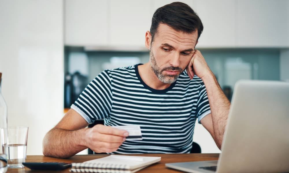 Consumer looks at credit card during January the worst month since 1992 for consumer confidence.jpeg