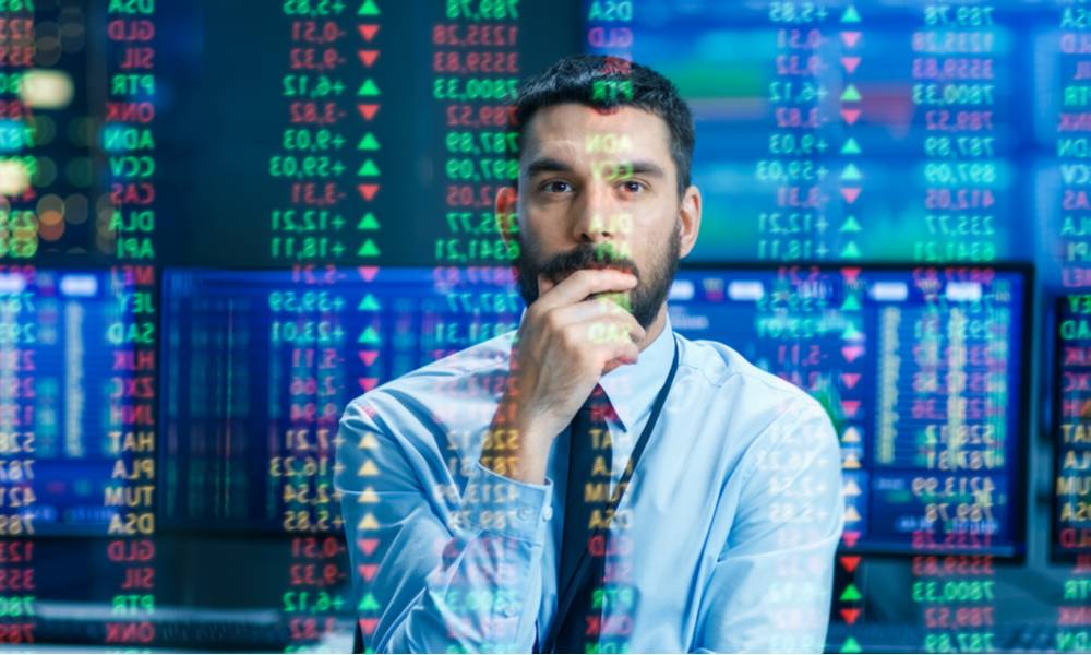 Stock market trader examines projected ticker numbers and graphs (1).jpg