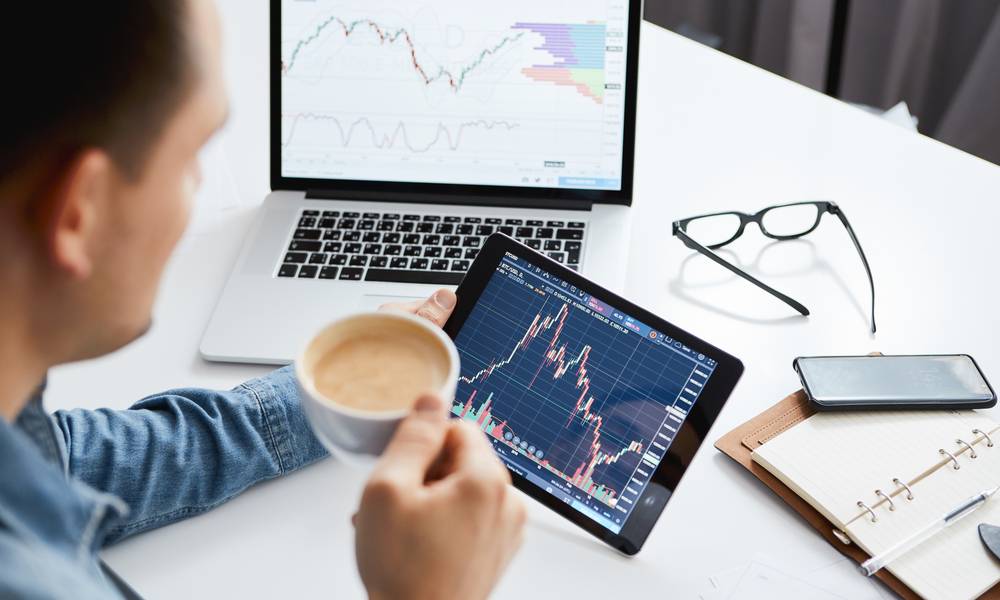 Investor watching the change of stock market on tablet.jpg